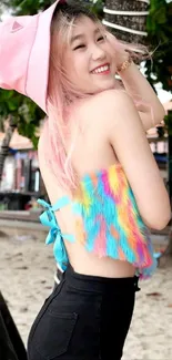 Smiling woman in colorful outfit at the beach with palm trees and vibrant vibes.