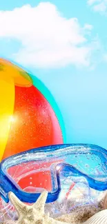 Colorful beach ball and goggles with bright sky.