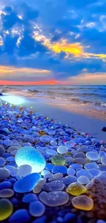 Vibrant stones on a beach with a stunning sunset over the ocean.