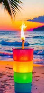 Colorful candle on beach at vibrant sunset.