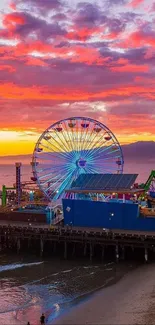 Ferris wheel at beach during a stunning sunset.