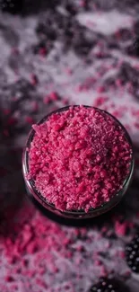 Pink sugar crystals surrounded by dark blackberries.