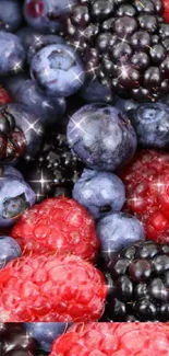 Vibrant mobile wallpaper of blackberries, blueberries, and raspberries with sparkles.