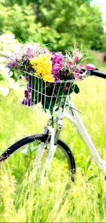 White bicycle with colorful flowers in a meadow.