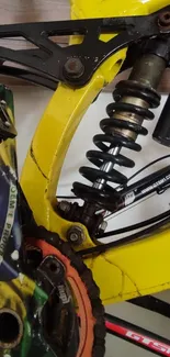 Close-up of a bike's vibrant yellow shock absorber.