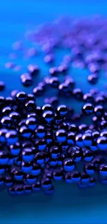 Dynamic vibrant blue wallpaper with glossy spheres for a modern phone design.