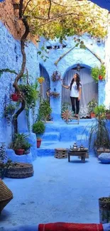 Vibrant blue Moroccan alley with plants.