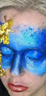 Artistic blue face with gold accents wallpaper.