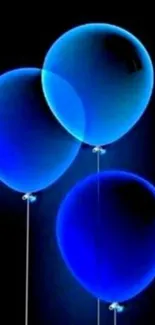 Three vibrant blue balloons on a black background.