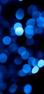 Vibrant blue bokeh wallpaper with glowing orbs creating a serene visual experience.