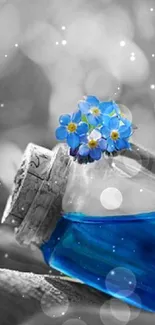 Blue bottle and flowers on grayscale background mobile wallpaper.