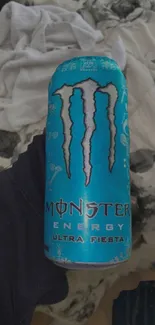 Vivid blue Monster Energy drink can against a contrasting background.