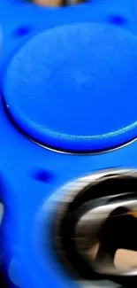 Close-up of a blue spinning fidget toy with dynamic motion effect.