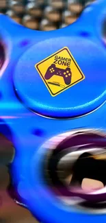 Vibrant blue gaming spinner wallpaper with gamer zone sign.