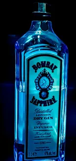 Elegant blue gin bottle in spotlight on phone wallpaper.