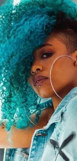 Person with vibrant blue curly hair and denim jacket.