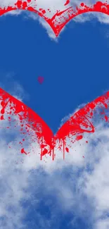 Blue heart with red splatter on cloudy background wallpaper.