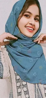 Smiling woman in blue hijab portrait for mobile wallpaper.