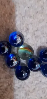 Cluster of blue marbles on a textured surface.