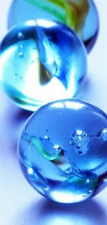 Three glossy blue marbles with striking details.