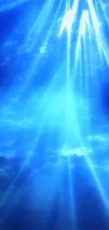 Blue ocean wallpaper with light rays shining through the water.