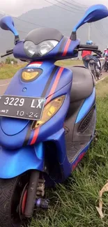 Blue scooter on a countryside road with scenic backdrop.