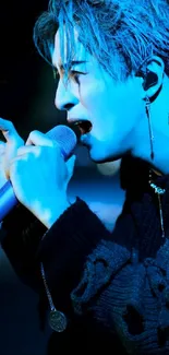 Blue-tinted singer passionately performing on stage wallpaper.