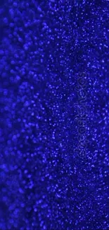 Vibrant blue glitter texture wallpaper with shimmering sparkles.