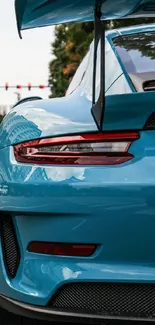 Vibrant blue sports car on an urban street, showcasing dynamic city life.