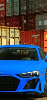 Azure blue sports car in front of shipping containers.