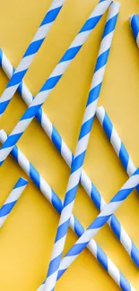 Blue and white striped straws on a yellow background wallpaper.