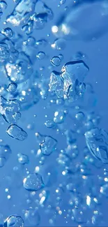 Vibrant blue water droplets in motion on a serene background.