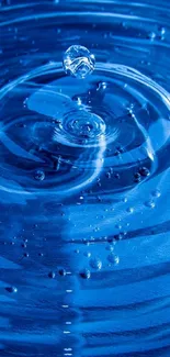 Close-up of a vibrant blue water ripple on a mobile wallpaper.