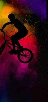 BMX rider silhouette on vibrant colorful background wallpaper.