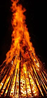 Bonfire flames blazing in the night with radiant orange hues.