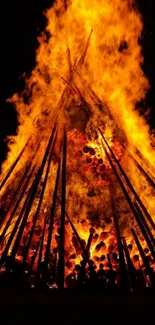 Bonfire with vibrant flames against a dark sky.