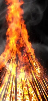 Vibrant bonfire with glowing flames on a dark background.