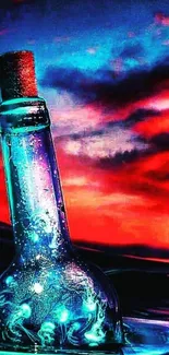 Glass bottle in vibrant sunset with ocean backdrop.