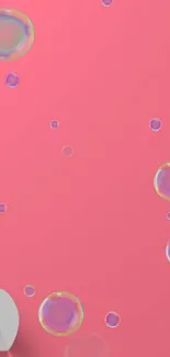 Playful pink mobile wallpaper with colorful bubbles.