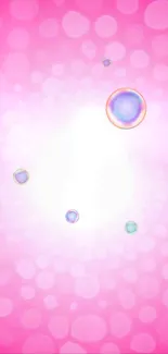 Pink wallpaper with floating bubbles on a bright background.