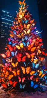 Butterfly adorned Christmas tree in the city at night.