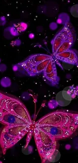 Purple and pink butterflies glowing on a dark background.