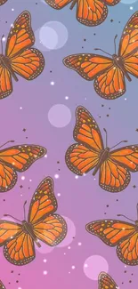 Orange butterflies on a colorful gradient background wallpaper.