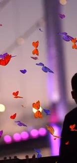 Silhouette with vibrant butterflies on a purple background wallpaper.