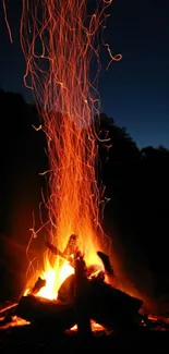 Vibrant campfire with night sky on a mobile wallpaper.