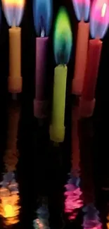 Colorful candle flames with reflections against a black background.