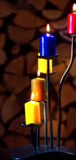 Vibrant candles on a metal stand with wood background.