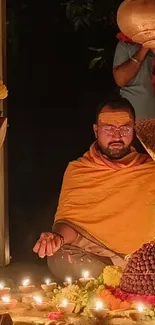 Man meditating in candlelit ritual setting with vibrant warm tones.