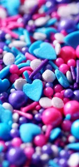 Colorful candy hearts in vibrant pink, blue, and purple hues.