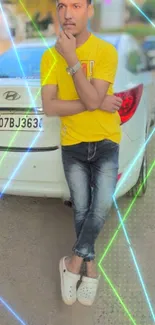 Man in yellow shirt leaning on white car with colorful lights.